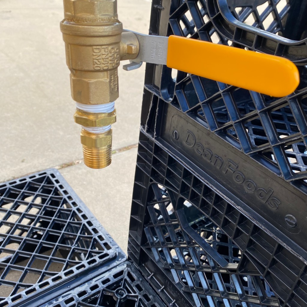 Water spigot over boxes at water distribution site.