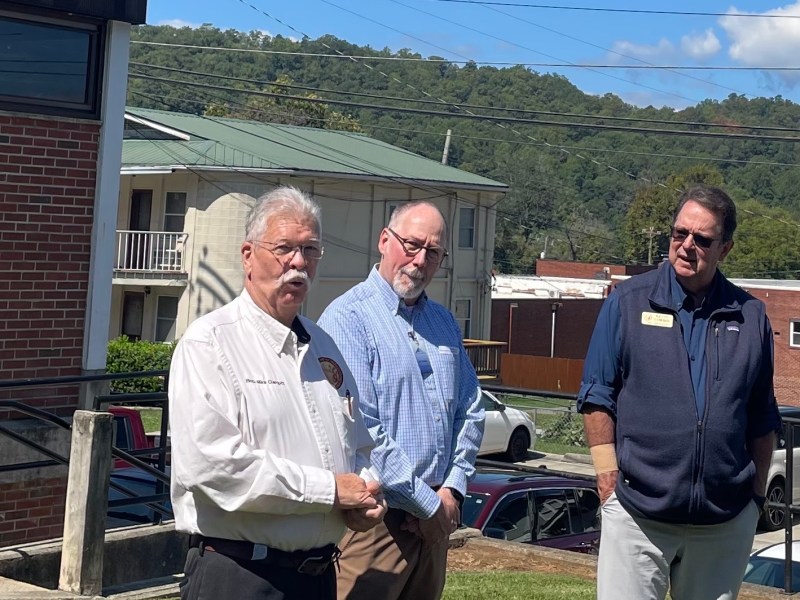 Rep. Mike Clampitt speaks at Mariana Black Library expansion groundbreaking while librarian Jeff Delfield and Sen. Kevin Corbin look on.